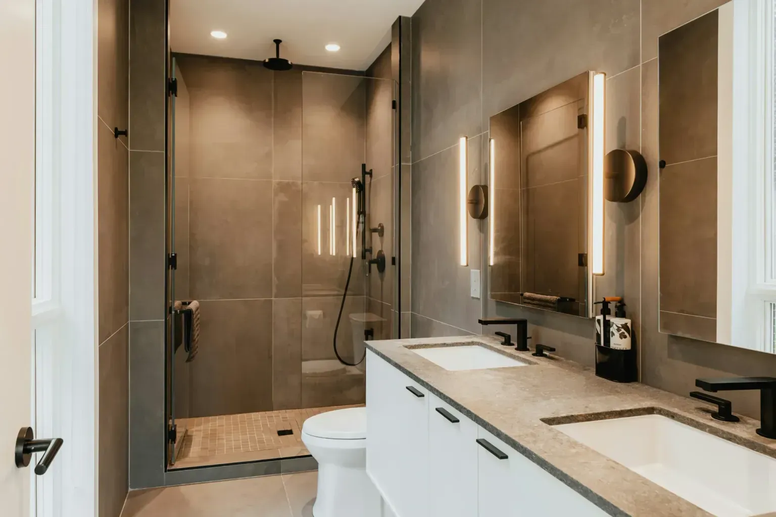 Bathroom remodel for veterans — gloved hands easing along a crisp finished edge