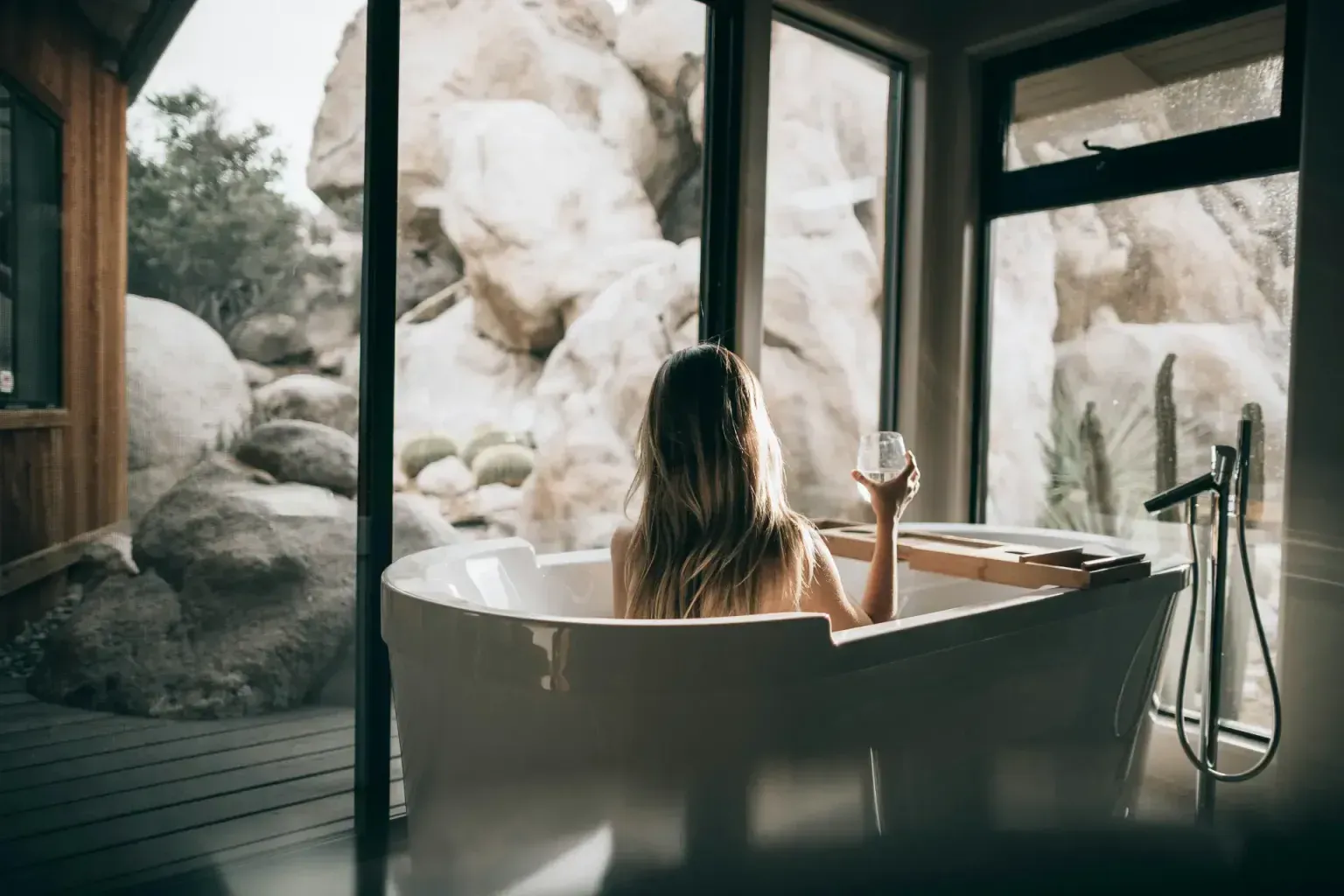 Bathroom remodel modern — a tradesperson making a careful final pass over the finished work