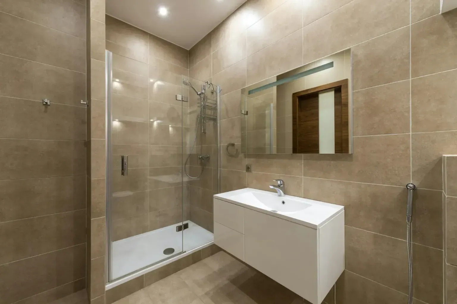 Bathroom remodel repair — clean unbroken lines of completed work running toward a commercial suite window